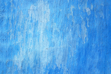 Fototapeta na wymiar Blue wall texture background. Old wall fragment with external peeled and cracked plaster