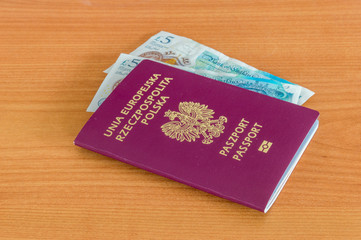 Polish biometric passport with Pound sterling banknotes.