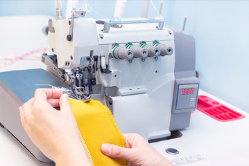 Sewing studio. Seamstress patch fabric. Overlock stitch. Overlock for sewing fabric. Tailoring