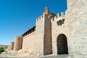 Fototapeta na wymiar Spain, the dramatic old city of Avila. A UNESCO site. View of the medieval defensive walls and a gate to the old, perfectly preserved, town.