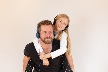 Father and daughter listening to music