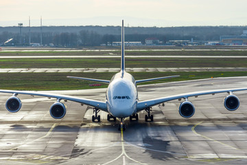 Huge wide-body aircraft on the steering track at the airport after arrival.