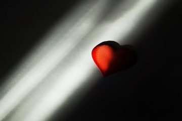 One red heart on black paper background for valentines day Valentines day background