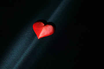 One red heart on black paper background for valentines day Valentines day background