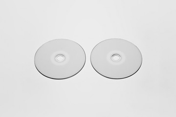DVD or CD disc with white isolated blank for branding design. CD jewel mock-up on soft gray...