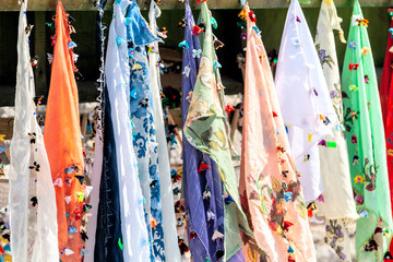 Rows of colorful scarves on sale