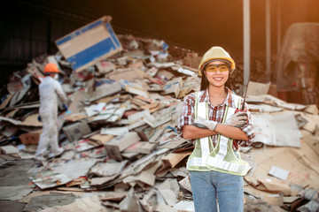 Female staff Controlling separation of paper for recycling