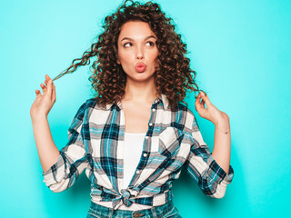 Portrait of beautiful smiling model with afro curls hairstyle dressed in summer hipster...