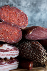A set of different types of raw smoked meat. Ham, bacon, sausage.