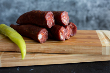 Delicious sausages served on wooden table.