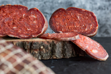 Delicious sausages served on dark background.