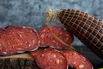 Delicious sausages served on dark background.