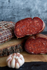 Delicious sausages served on dark background.