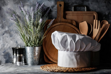 White cook hat in kitchen and free space for your decoration 