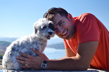 Young Man Traveling with his White Havanese Dog