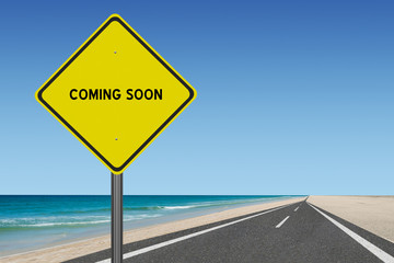 Coming Soon sign on ocean road background.