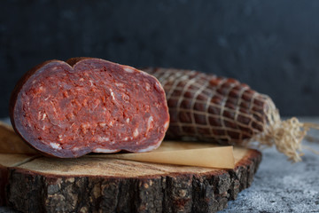 Delicious sausages served on wooden table.