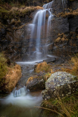 Fototapeta na wymiar A small waterfall from a mountain rivulet at the side of the road near the Storey Arms in the Brecon Beacons, South Wales, UK