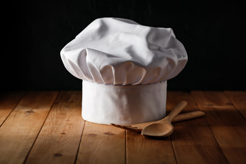White cook hat in kitchen and free space for your decoration 