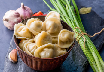 boiled dumplings with filling and sauce on the plate. Steam over a plate