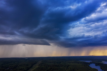 Naklejka na ściany i meble Aerial view of heavy thunderclouds over the forest of Karelia