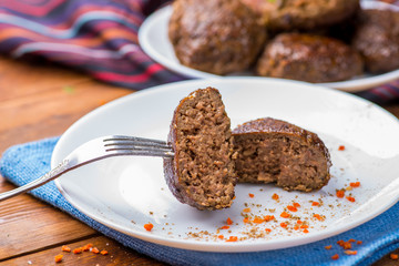 cutlet cut in half on the background whole on a plate