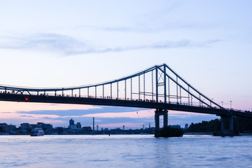 High bridge, river, ships and bright sunset.