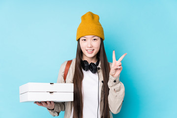 Young chinese woman holding pizzas isolated showing number two with fingers.