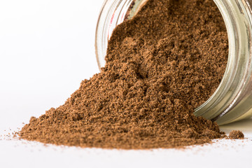 Ground Allspice Spilled from a Spice Jar