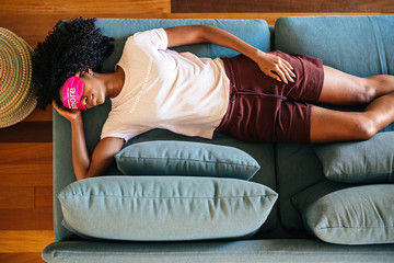 Young black lady using eye mask for sleep