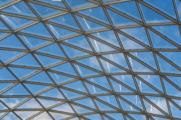glass ceiling dome in a modern shopping center against a blue sky