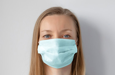 Light hair woman wearing medical mask