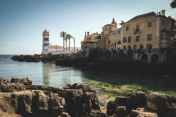 Lighthouse by the sea in a small bay in the town of Cascais in Portugal in summer day