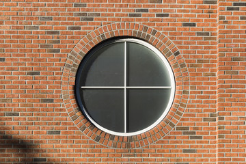 Round window in brick wall.