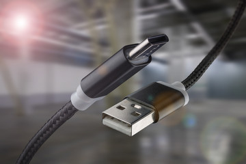 USB cable and USB type-C on an industrial background. - Powered by Adobe