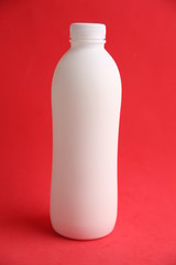 liquid yogurt bottle in color background