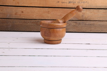 cooking wooden mortar in color background