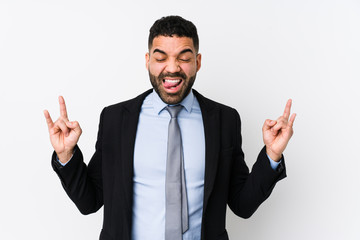 Young latin business woman against a white background isolated showing rock gesture with fingers