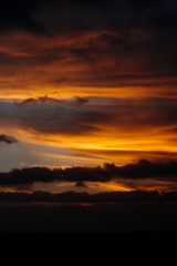 Fototapeta na wymiar cloudy sunset colourful orange red sky