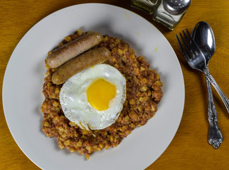 corn beef hash with fried egg and sausage