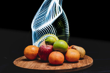 Fruta variada de colores con fondo negro  luces