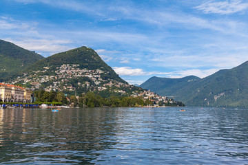 Beautiful  panorama view of Lugano Lake, cityscape of Lugano, mountain Monte Bre and Swiss Alps on a sunny summer day with blue sky cloud, Canton of Ticino, Switzerland