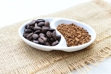 Coffee beans, accompanied by processed coffee powder