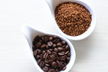 Coffee beans, accompanied by processed coffee powder