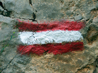 Pedestrian mark on the stone for the orientation of the walker while walking along the path