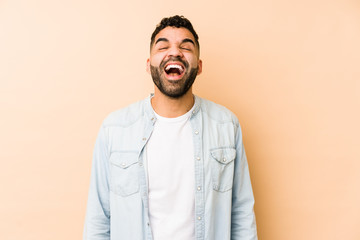 Young mixed race arabic man isolated relaxed and happy laughing, neck stretched showing teeth.