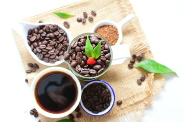 Fototapeta na wymiar Coffee beans, accompanied by processed coffee powder