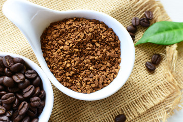 Coffee beans, accompanied by processed coffee powder