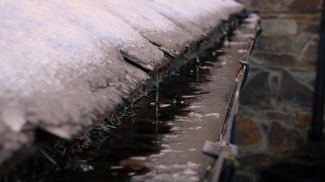 Snow Melting Off a Roof and Dripping Into a Gutter, Ireland