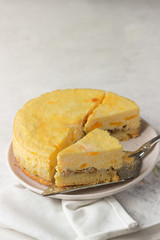 Pumpkin cheesecake with caramel sauce, light grey stone background. Selective focus. 